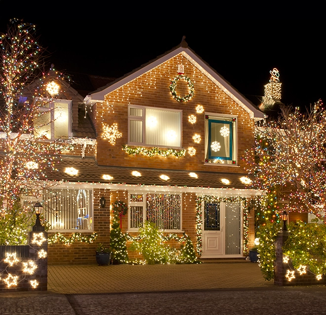 A beautifully decorated house illuminated with festive lights.