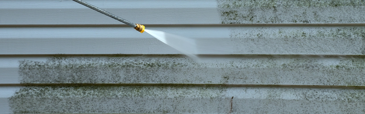 Surface being cleaned using pressure washing.