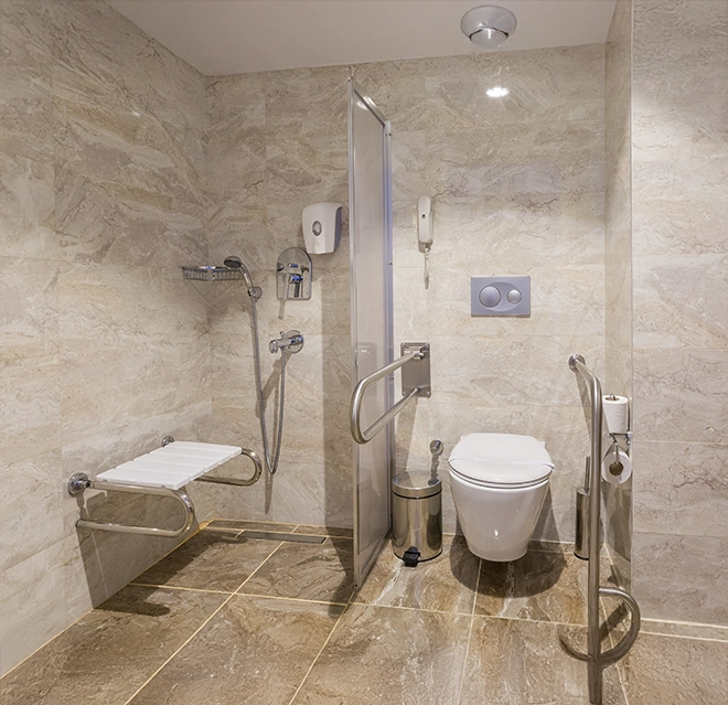Modern bathroom with tiled walls, featuring a shower.
