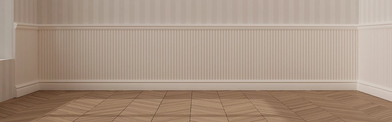 A spacious room with herringbone-patterned wooden flooring and elegant striped wallpaper featuring decorative wainscoting.
