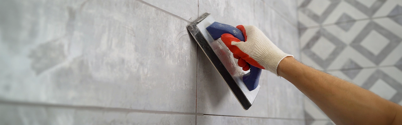 MRH employee grouting wall tiles.